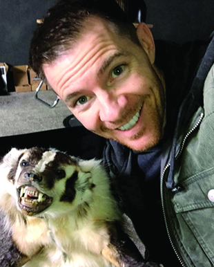Minson posing with his custom built animatronic badger on set before filming a GRIP6 commercial.
